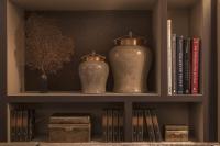 a book shelf with two vases and books at La Villa des Ternes in Paris
