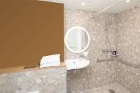a bathroom with a sink and a shower with a mirror at Residence Inn by Marriott Paris Didot Montparnasse in Paris