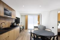 a room with a kitchen and a table with chairs at Residence Inn by Marriott Paris Didot Montparnasse in Paris