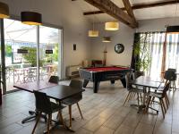 a room with a pool table and ping pong ball at Kyriad Montpellier Aéroport - Gare Sud de France in Mauguio