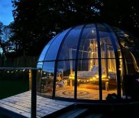 a glass dome with a bed inside of it at Dihan Evasion in Ploemel