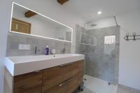 a bathroom with a white sink and a shower at Gite sur la Founintrouze in Fabrezan