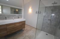 a bathroom with a sink and a glass shower at Gite sur la Founintrouze in Fabrezan