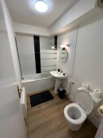 a bathroom with a white toilet and a sink at Le Jacquard in Calais