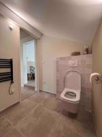 a bathroom with a toilet with a tile floor at Casa Mariuccia in Algajola