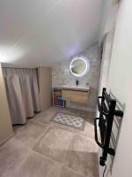 a small bathroom with a sink and a mirror at Casa Mariuccia in Algajola