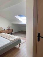 a bedroom with a bed and a skylight at Casa Mariuccia in Algajola