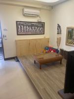 a waiting room with a table and a couch at Ribbed Birch B&amp;B in Hualien City