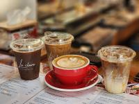 a table with three cups of coffee and a red mug at Haadson Resort & Koh Raham in Haad Son