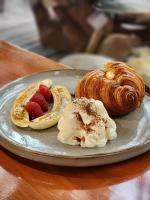 a plate of pastries and strawberries on a table at Haadson Resort & Koh Raham in Haad Son