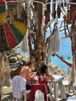 a man and a woman sitting at a table on the beach at Haadson Resort & Koh Raham in Haad Son