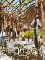a dining room with white chairs and a table at Haadson Resort & Koh Raham in Haad Son