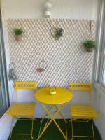 a yellow table and two chairs in a room at studio confortable 30 m2 proche plage in La Seyne-sur-Mer