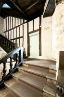 a set of stairs in a building with a door at Studio Design Sous Toits IntraMuros Vue Cathédrale in Vannes