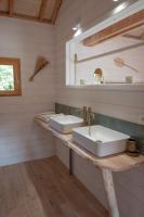 a bathroom with two sinks and a mirror at Dihan Evasion in Ploemel
