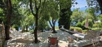 a patio with hammocks and tables and trees at Rooms Villa Lucija in Kraljevica
