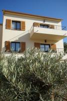 a house with a hedge in front of it at Résidence CATALINA in Saint-Florent