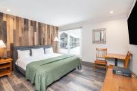 a bedroom with a bed and a table and a window at Mountainside Inn 208 by Alpine Lodging Telluride in Telluride