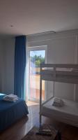 a bedroom with two bunk beds and a window at Nànnì guest home in Pozzovetere