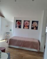 a bedroom with three pictures of roses on the wall at Nànnì guest home in Pozzovetere