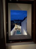 a picture of a swimming pool in a window at Gite sur la Founintrouze in Fabrezan