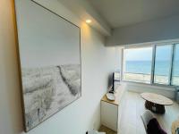 a living room with a large picture of the ocean at Studio FRONT DE MER rénové in Le Barcarès