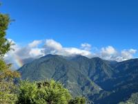 a rainbow in the sky over a mountain range at Julie&#39;s Garden, Cingjing - Fon Chin Homestay in Ren&#39;ai