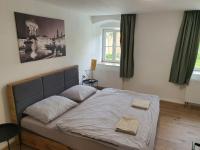Postel nebo postele na pokoji v ubytování Apartmány ČERNÝ KOHOUT