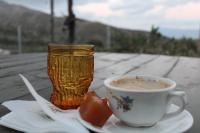 a cup of coffee sitting on a table with a drink at TRADITIONAL HOUSE MARIA in Azoyirás