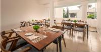 a dining room with wooden tables and chairs at Beverly Hills Hotel in Mount Lavinia