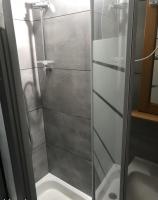 a shower with a glass door in a bathroom at Location Sète les pieds dans l&#39;eau in Sète