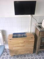 a flat screen tv on top of a wooden cabinet at Location Sète les pieds dans l&#39;eau in Sète