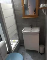 a small bathroom with a sink and a mirror at Location Sète les pieds dans l&#39;eau in Sète