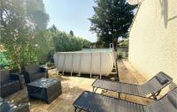 a patio with a tub and a table and chairs at Amazing Home In Lapalud With Outdoor Swimming Pool, Wifi And Private Swimming Pool in Lapalud