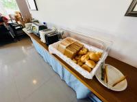 a buffet with bread and other food on a table at Junyi Landscape Villa in Ren&#39;ai