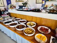 a buffet with many plates of food on a table at Junyi Landscape Villa in Ren&#39;ai