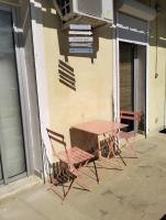 a table and chairs sitting outside of a building at Logement zen love, 5 mn de la plage in Toulon