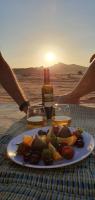 a plate of food on a table in the desert at Rum Under The Stars Camp in Wadi Rum
