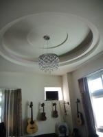 a room with guitars on the ceiling and a chandelier at Xinchuan B&amp;B in Dayi