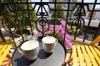 two cups on a table on a balcony with flowers at Romeo&amp;Juliet in Opatija