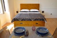 a bedroom with a bed with two blue plates on a table at Romeo&amp;Juliet in Opatija