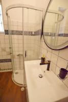 a bathroom with a sink and a shower with a mirror at Romeo&amp;Juliet in Opatija