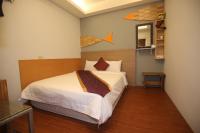a bedroom with a bed and a wall with surfboards on it at Kenting Waterfront Hotel in Kenting