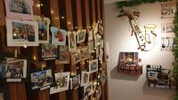 a wall with pictures and christmas lights on it at Shanghai Time in Hualien City