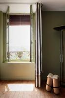 a living room with a window and a pair of shoes at Au Petit Thouars in Thouars