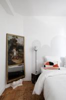 a bedroom with two beds and a painting on the wall at Au Petit Thouars in Thouars