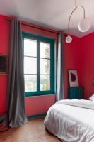 a red bedroom with a bed and a window at Au Petit Thouars in Thouars