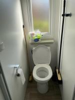 a small bathroom with a toilet and a window at Mobil-home (Clim, Tv)- Camping Narbonne-Plage 4* - 022 in Narbonne-Plage