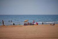 a group of people sitting on the beach at Mobil-home (Clim, Tv)- Camping Narbonne-Plage 4* - 022 in Narbonne-Plage