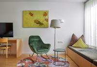 a living room with a green chair and a couch at Bonawinkel NEU in Gaschurn